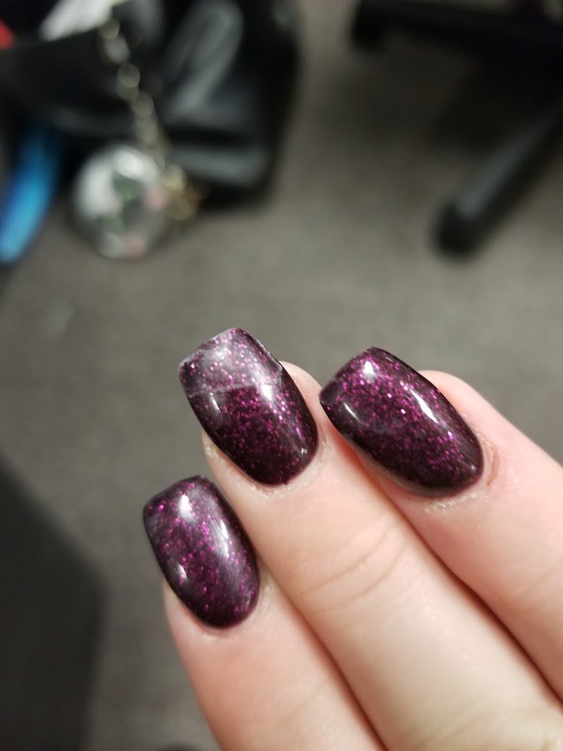 Nail salon stations with polished manicure tools.